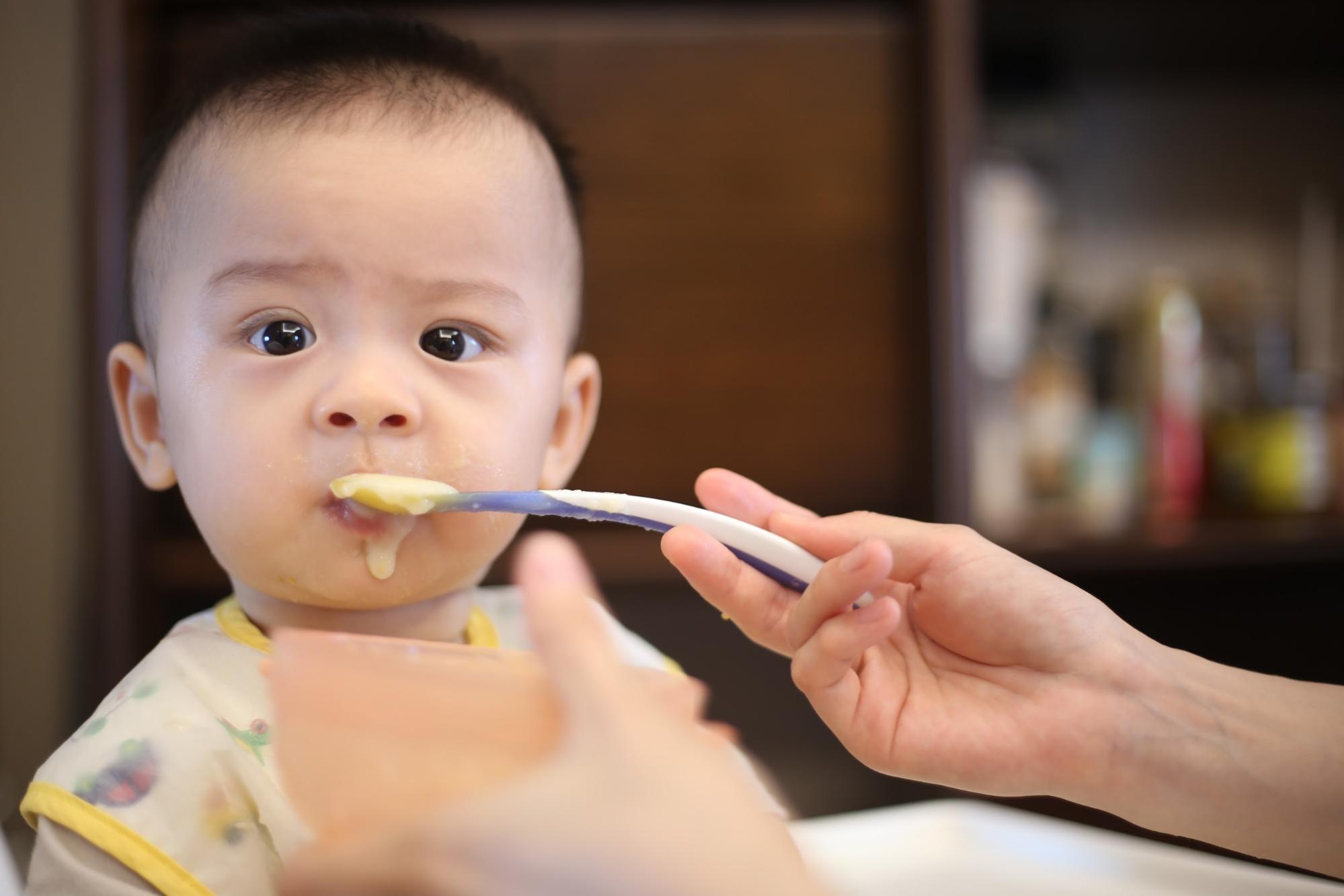 a baby while eating his meal
