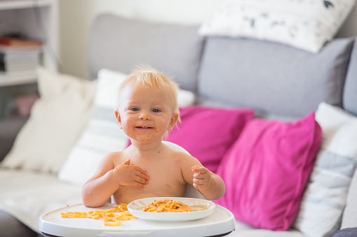 baby eating pasta