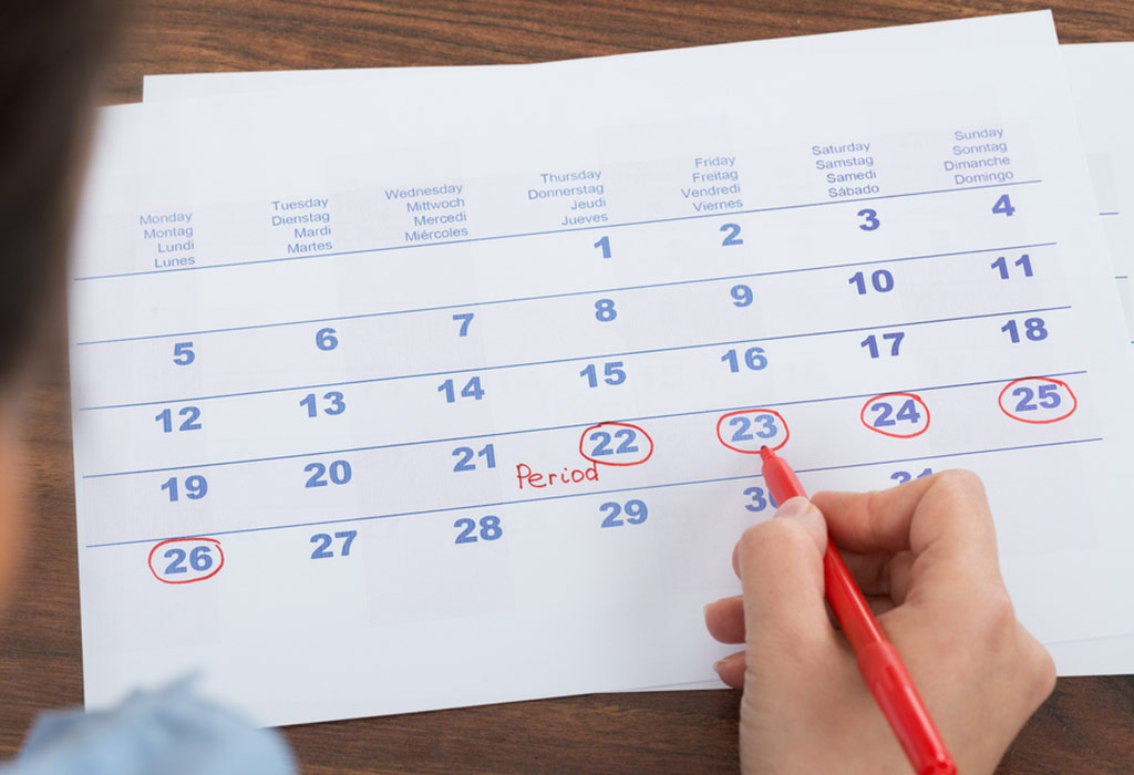 woman holding calendar with marked missed period 