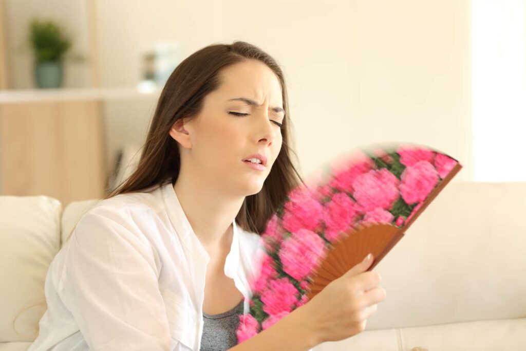 Overheated woman suffering from excessive sweating