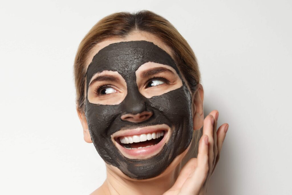 woman using charcoal mask