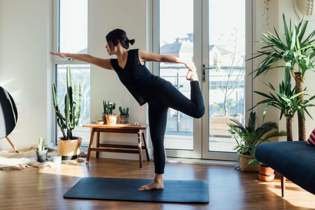 woman practicing yoga at home