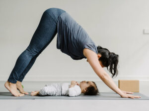 a woman doing exercise in front of her baby after vaginal delivery