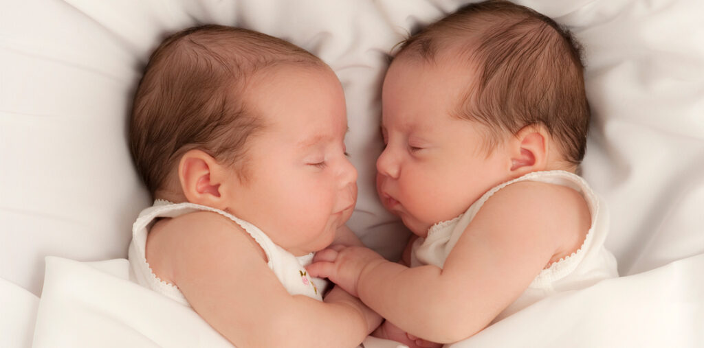 picture of twins holding each other's hand