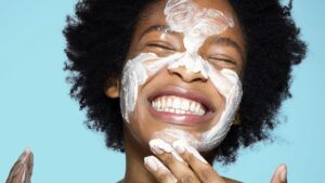 woman applying sunscreen of her face