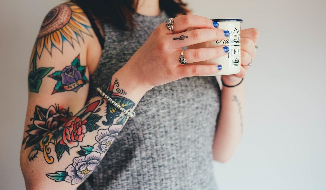tattooed girl holding a mug