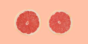 two sliced oranges illustrated as sore boobs