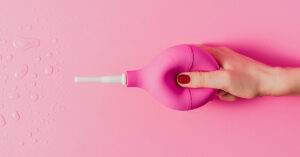 cropped shot of woman holding pink enema